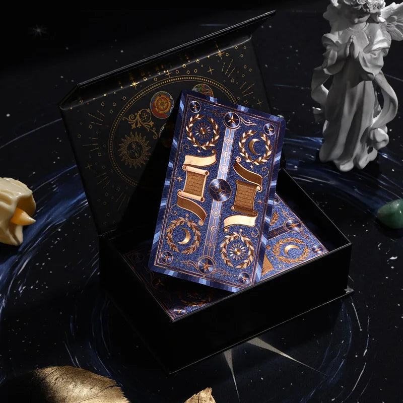 Blue and gold foil tarot deck displayed in an open celestial gift box