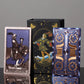 Knight of Cups tarot card and ornate blue gold card back beside decorative tarot gift box