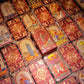 Crimson and gold floral tarot cards with matching illustrated presentation box