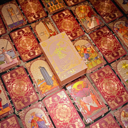 Crimson floral gold foil tarot deck with pink presentation box and card spread